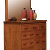 light brown wooden dresser with multiple drawers and a mirror