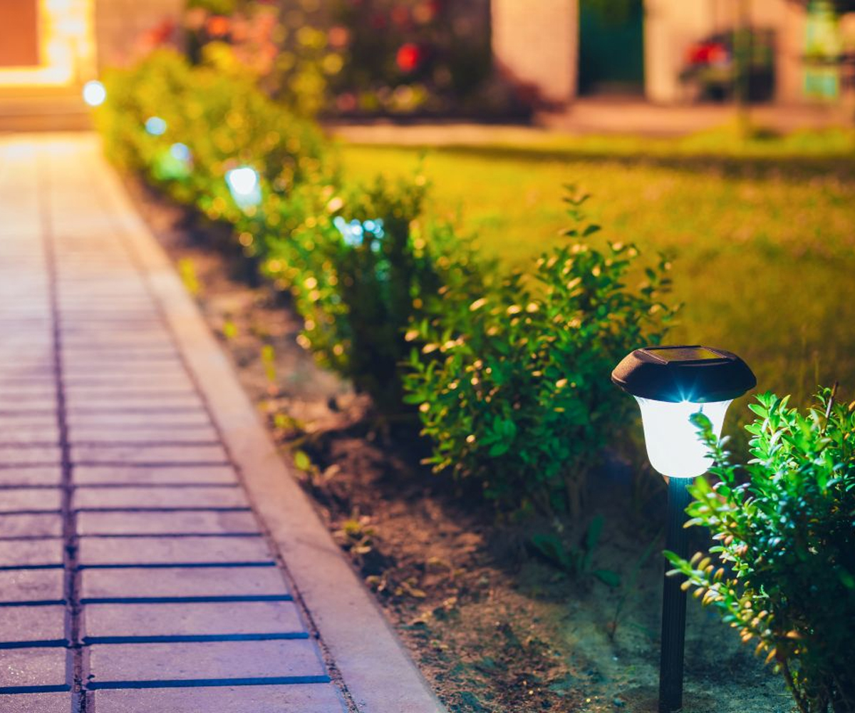 Outdoor path lighting along landscaped walkway.
