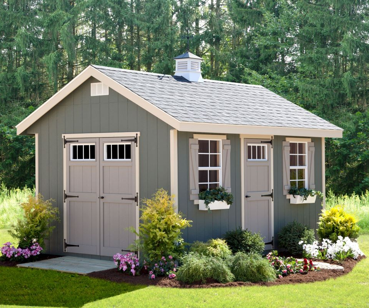 Garden shed with double doors, windows, and flower boxes.